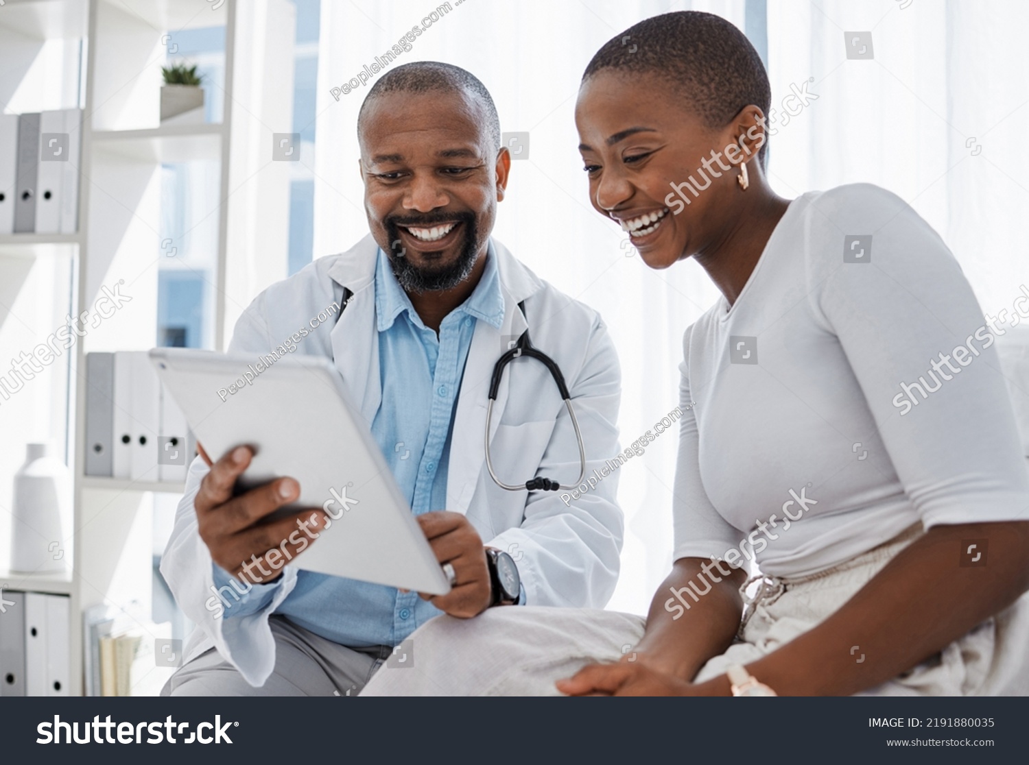 Doctor, healthcare and medicine with a patient talking test results and progress on a tablet in a hospital clinic. Trust, help and medical consulting with a professional medicare worker in his #2191880035