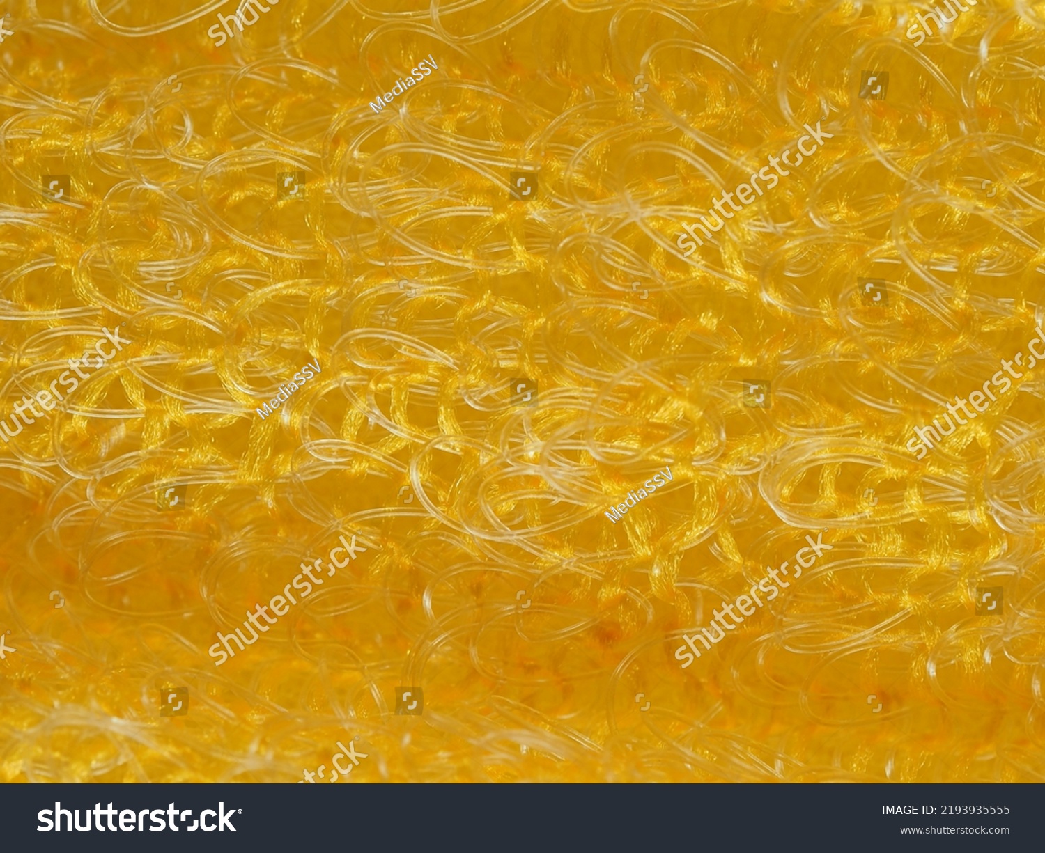 close up, background, texture, large horizontal banner. heterogeneous surface structure bright saturated yellow sponge for washing dishes, kitchen, bath. full depth of field. high resolution photo #2193935555
