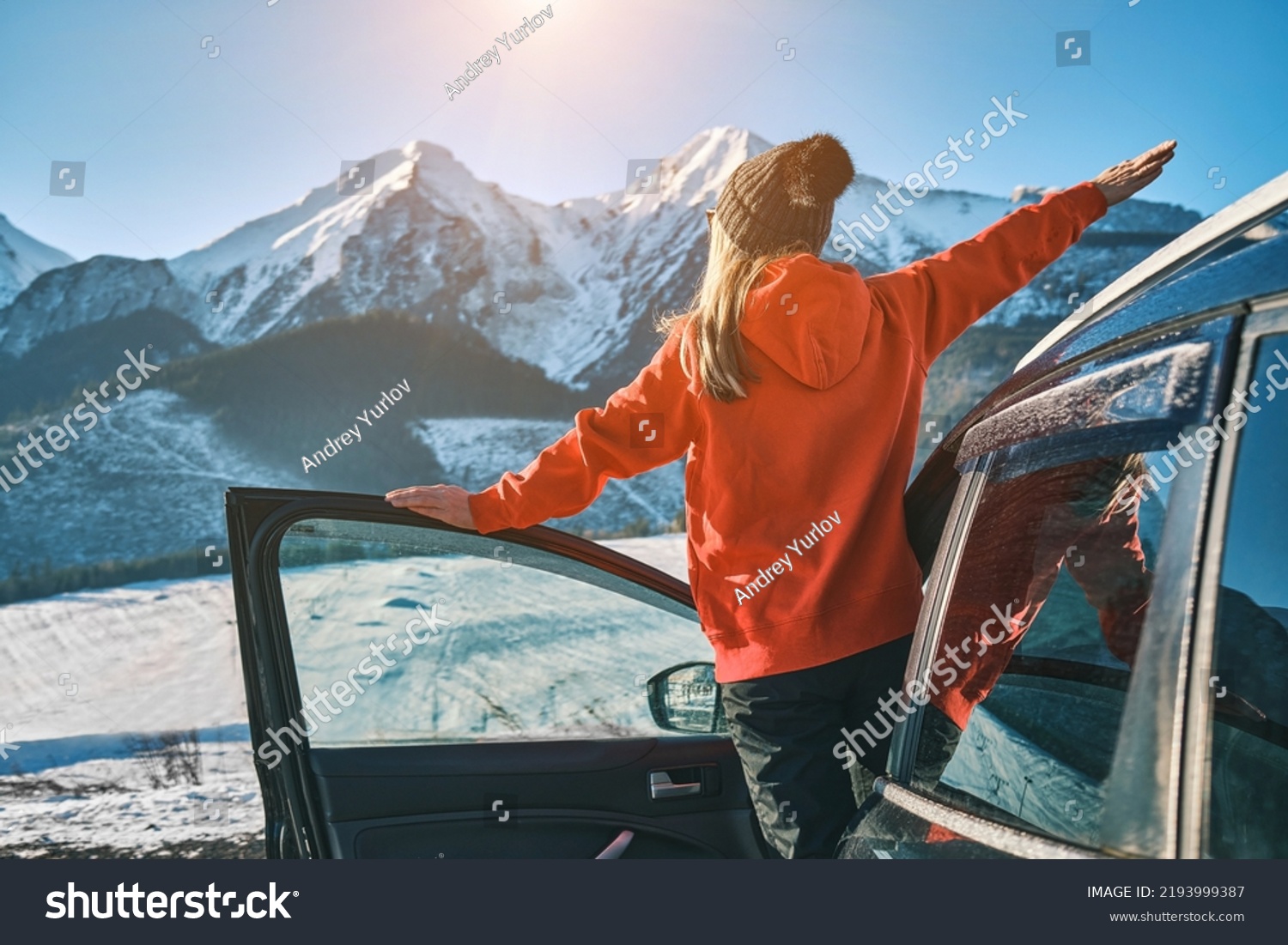 Woman traveling exploring, enjoying the view of the mountains, landscape, lifestyle concept winter vacation outdoors. Female standing near the car in sunny day, travel in the mountains, freedom #2193999387