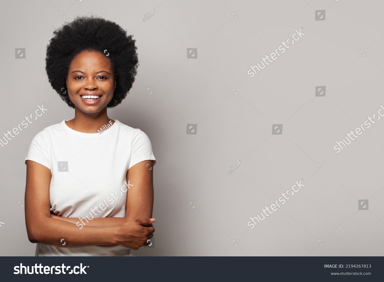 Happy smiling woman wearing white empty t-shirt standing on white background #2194267813
