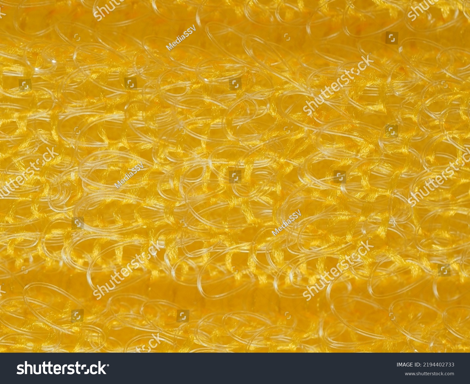 close up, background, texture, large horizontal banner. heterogeneous surface structure bright saturated yellow sponge for washing dishes, kitchen, bath. full depth of field. high resolution photo #2194402733