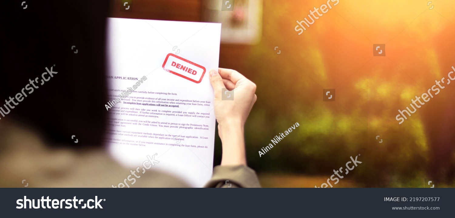 Young brunette long hair girl cries hysterically after being denied a mortgage loan.Depressive sad state female millenial holding  rejection document copy space banner #2197207577