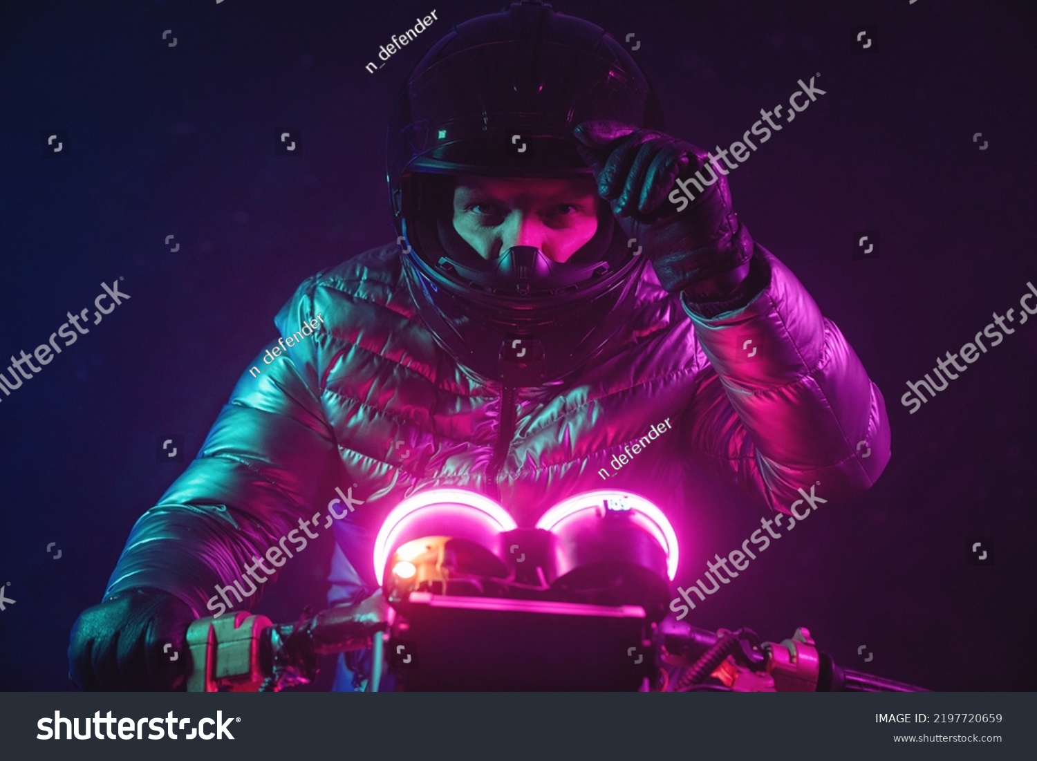 A futuristic motorbiker on the neon light motorcycle close up. #2197720659
