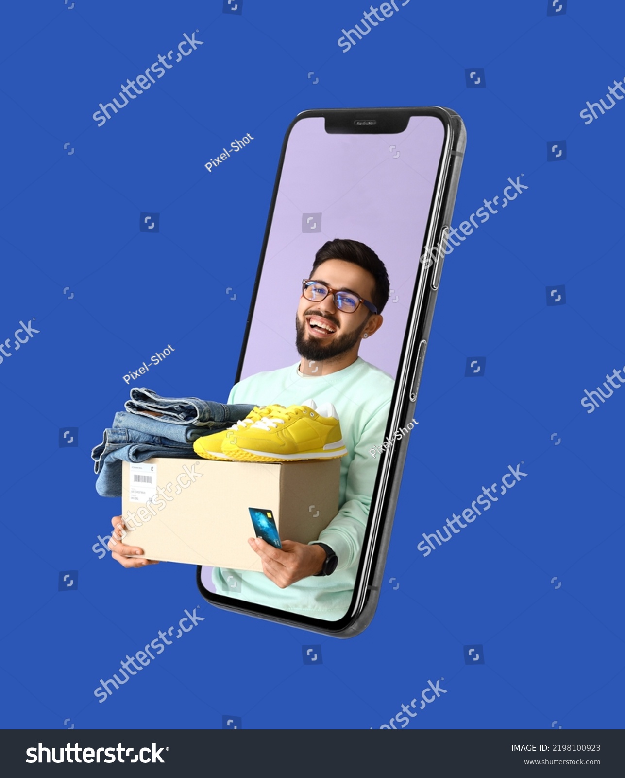 Happy young man with parcel looking out of smartphone screen on blue background. Online shopping concept #2198100923