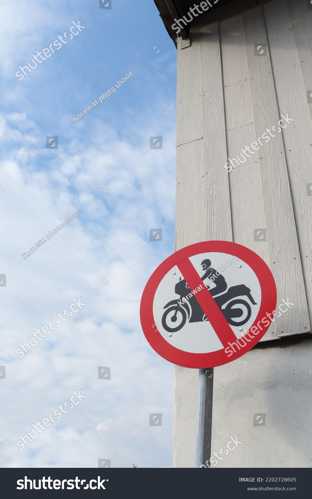 Motorcycle prohibition signs are installed in community areas to prevent motorcycles from entering area to prevent accidents. exercise area has installed signs prohibiting motorcycles from entering  #2202728605