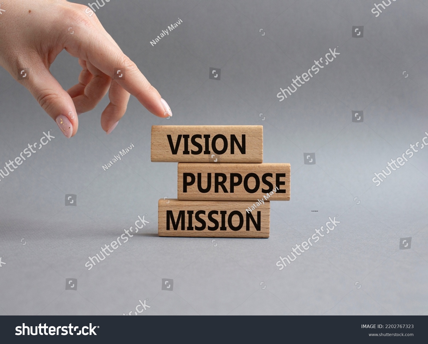 Vision Purpose Mission symbol. Concept word Vision Purpose Mission on wooden blocks. Beautiful grey background. Businessman hand. Business and Vision Purpose Mission concept. Copy space. #2202767323