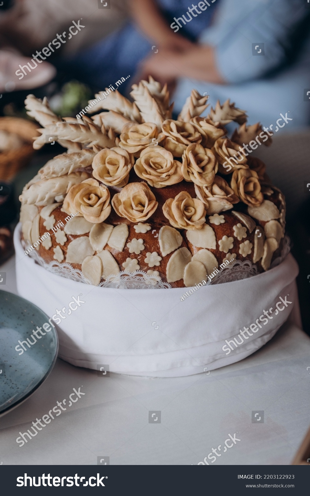 Wedding bread - loaf (cake). Wedding bread. A loaf is decorated with flowers, stables, ears of dough. Wedding. Bride and groom. Ukrainian tradition #2203122923