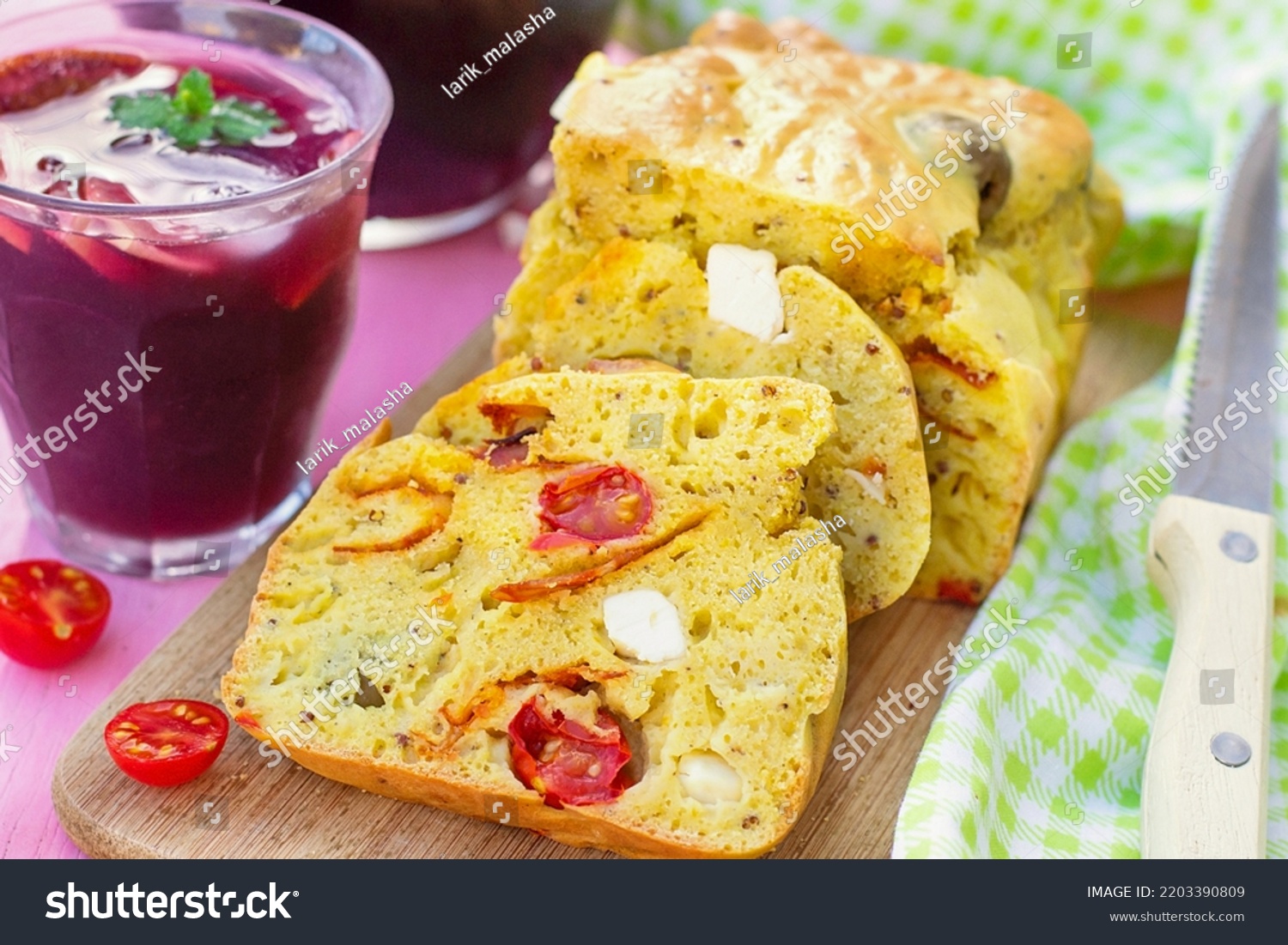 Savoury cake with curry, chorizo, cherry tomatoes, olives and feta cheese. Selective focus #2203390809