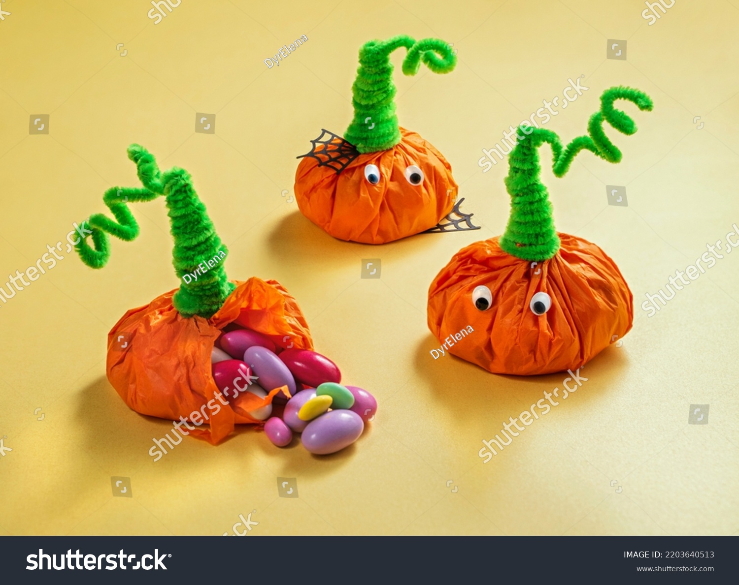 halloween treats for kids wrapped in the shape of pumpkins. Party favor bag with colorful candy. Trick or Treat, concept for Halloween #2203640513