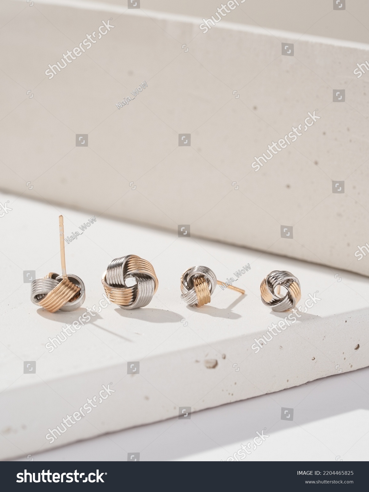 Close up golden and silver stud earrings. Beautiful earrings on white background. Any size, color and shape. Women accessories. #2204465825