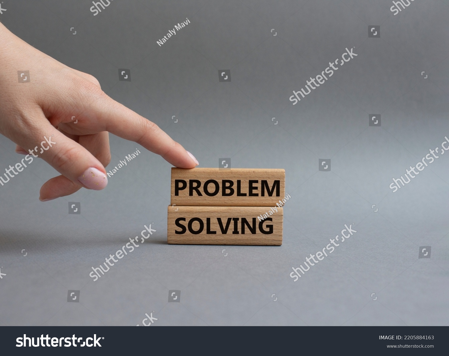 Problem solving symbol. Concept word Problem solving on wooden blocks. Beautiful grey background. Businessman hand. Business and concept. Copy space #2205884163