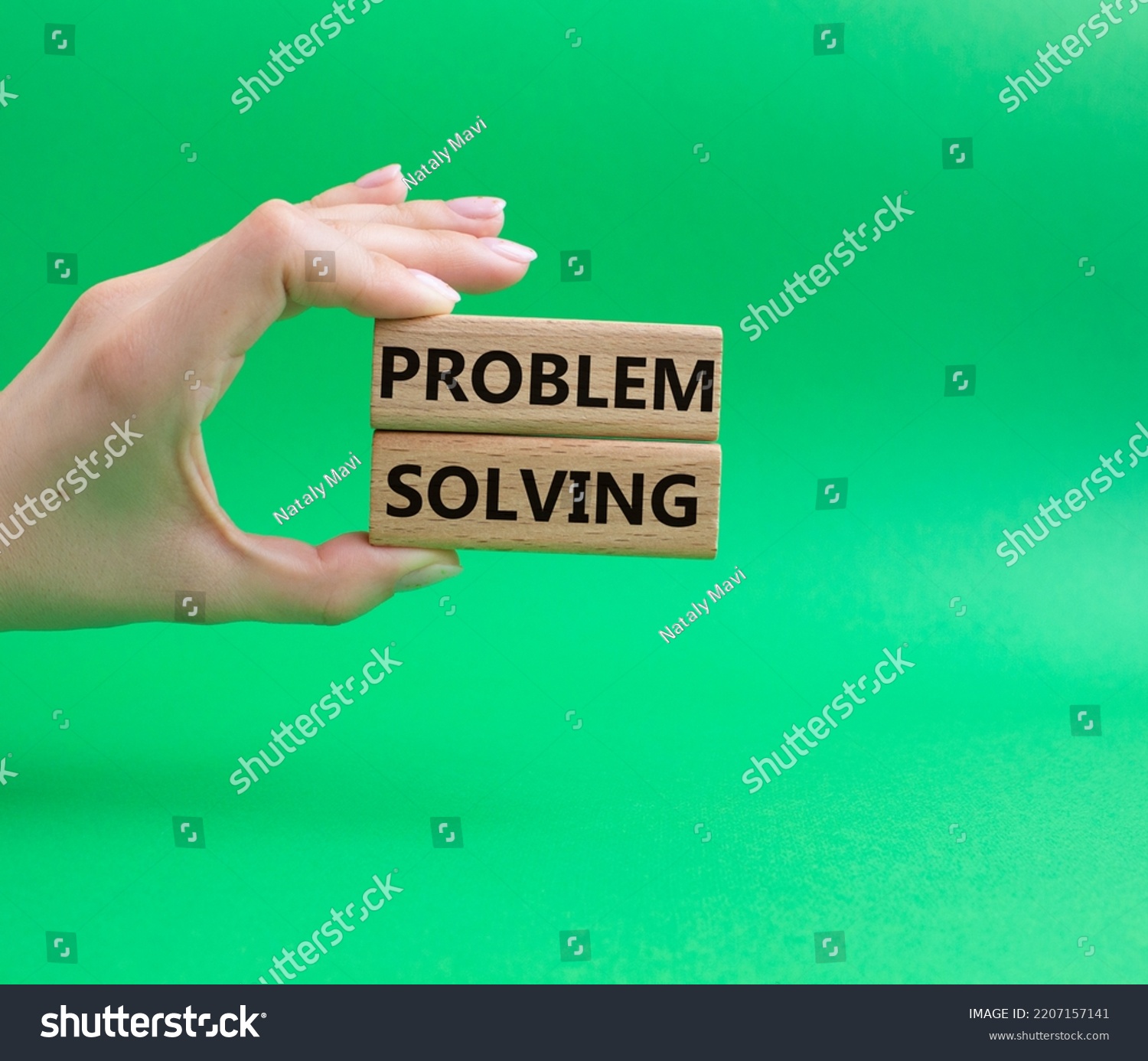 Problem solving symbol. Concept word Problem solving on wooden blocks. Beautiful green background. Businessman hand. Business and concept. Copy space #2207157141