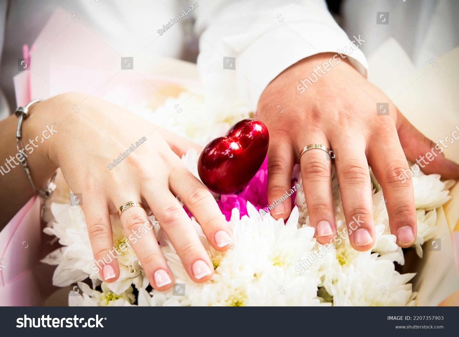 Hands of lovers with wedding rings. Wedding day of a heterogeneous couple. #2207357903