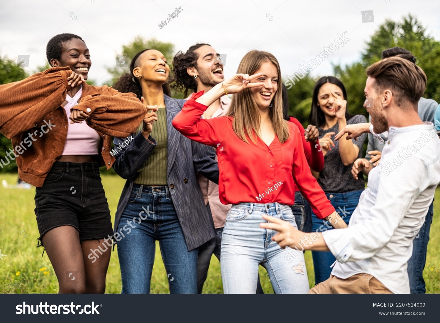 Multiracial group of friends dancing together on the park - Multiethnic friends having fun in the university campus #2207514009