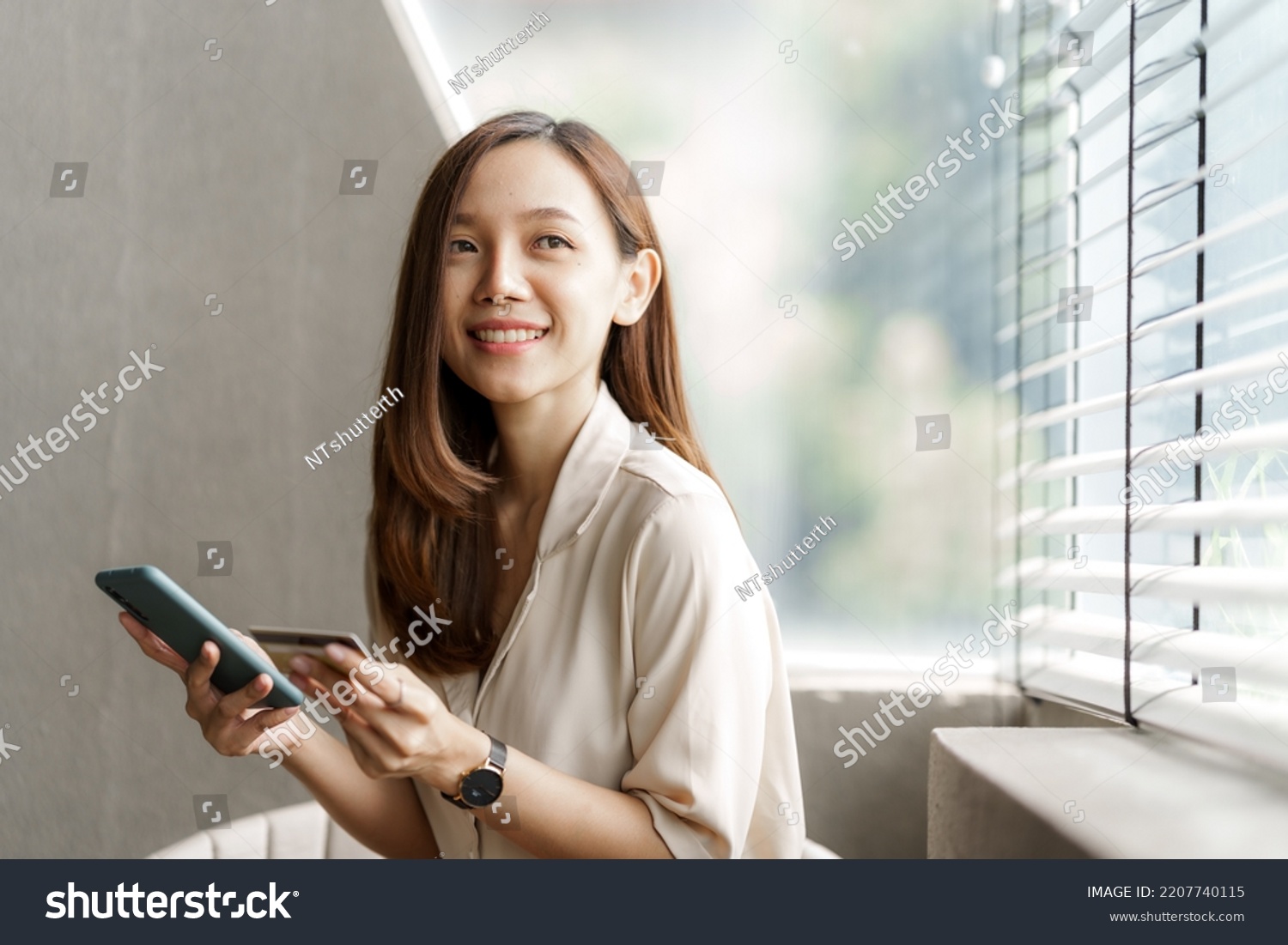 Young pretty asian female using credit card to do online product shopping on her mobile, cashless concept. #2207740115