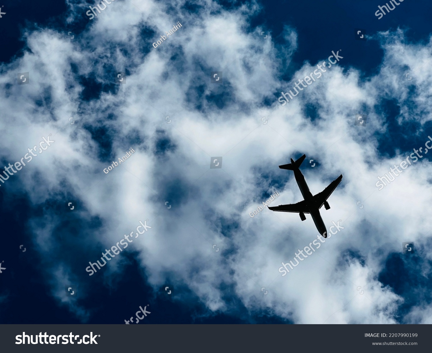 The aircraft flying on the cloudy sky background #2207990199