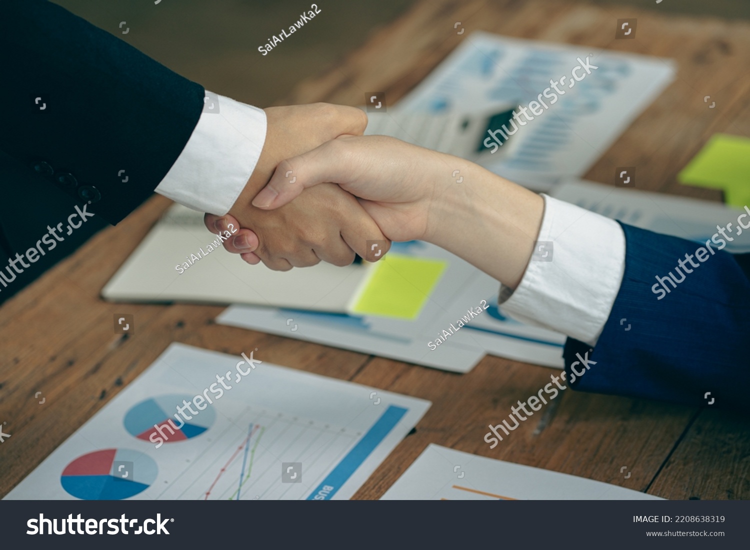 business people shake hands to make an agreement during a board meeting in the office Teamwork, agreement, cooperation, real estate business concept. #2208638319