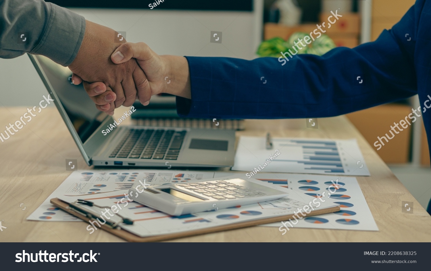 business people shake hands to make an agreement during a board meeting in the office Teamwork, agreement, cooperation, real estate business concept. #2208638325