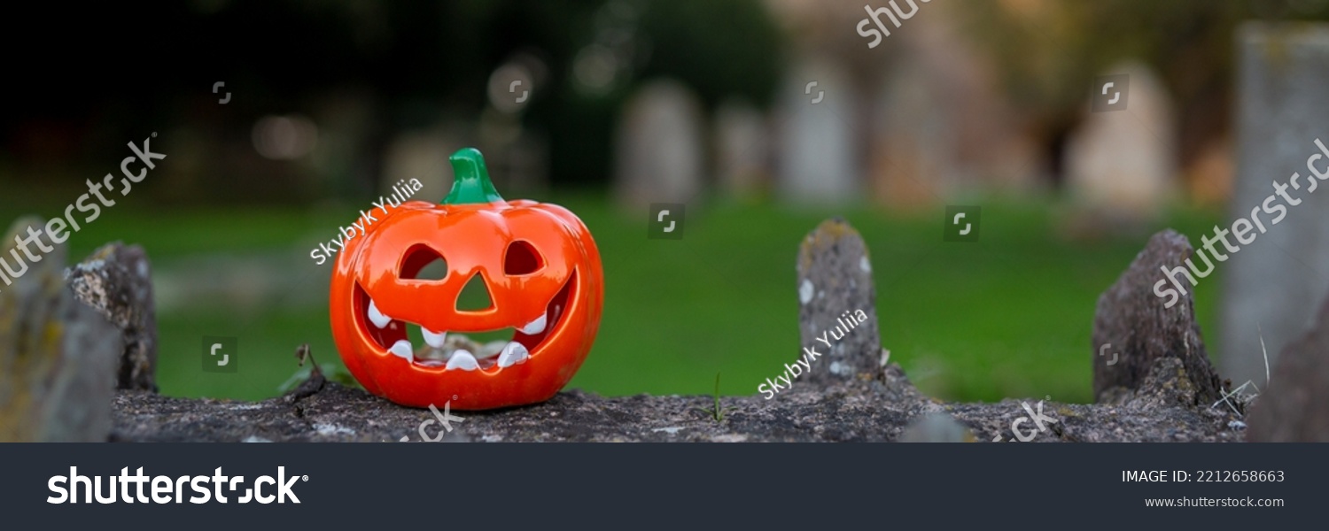 Orange decorative pumpkin for Halloween on a stone fence. Banner #2212658663