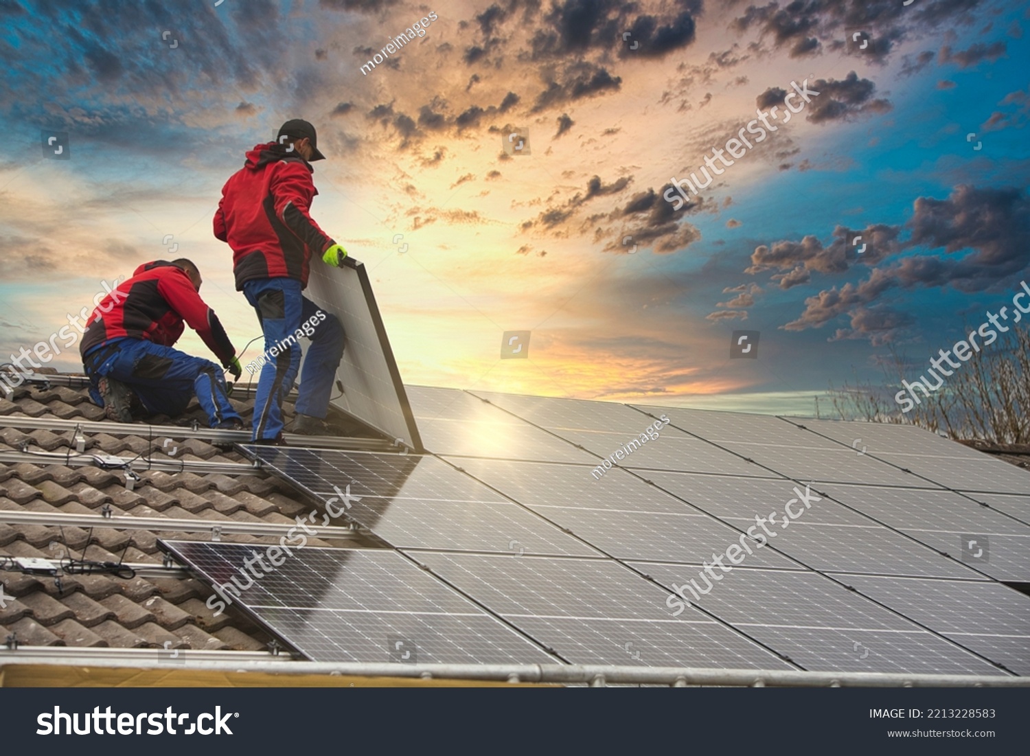 Installing solar photovoltaic panel system. Solar panel technician installing solar panels on roof. Alternative energy ecological concept.
 #2213228583