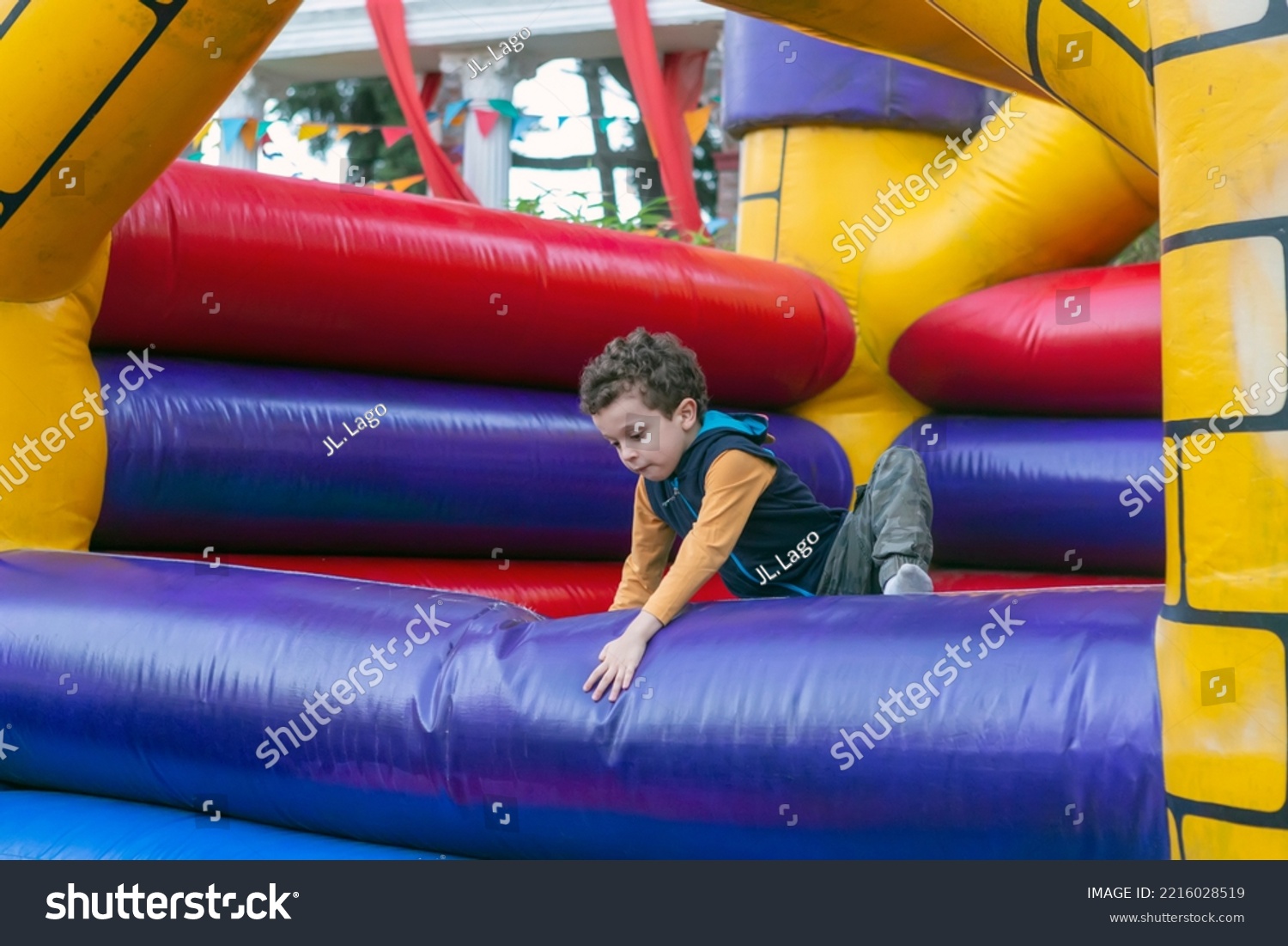 handsome boy playing in bouncy castle #2216028519