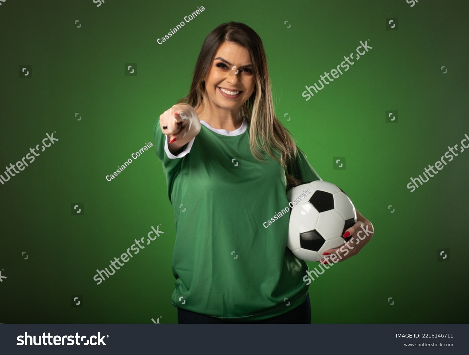woman soccer fan cheering for her favorite club and team. world cup green background. #2218146711