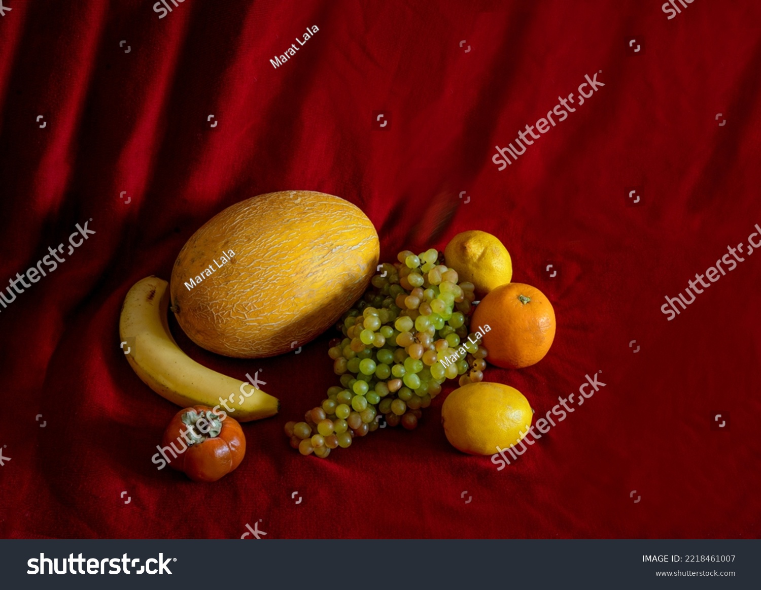 Yellow Fruits ( mellow, banan, lemon and orange and green grapes and persimmon) on dark red background #2218461007