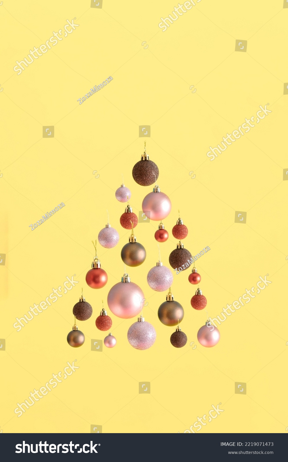 Modern aesthetic with Christmas tree shape made of colorful baubles against bold yellow background. Minimal New Year concept. Holiday spirit visual. #2219071473