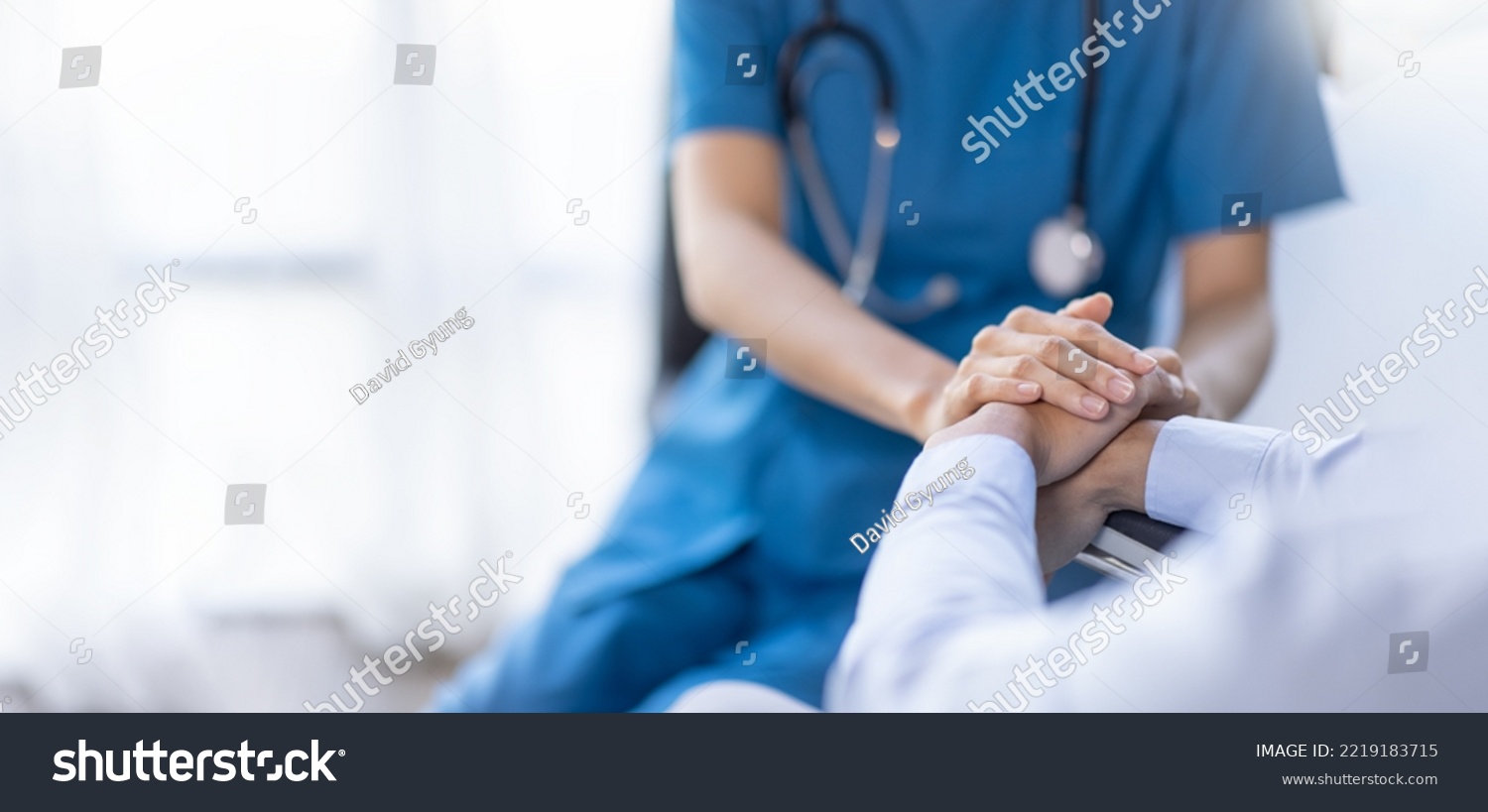 Cropped shot of a female nurse hold her senior patient's hand. Giving Support. Doctor helping old patient with Alzheimer's disease. Female carer holding hands of senior man #2219183715