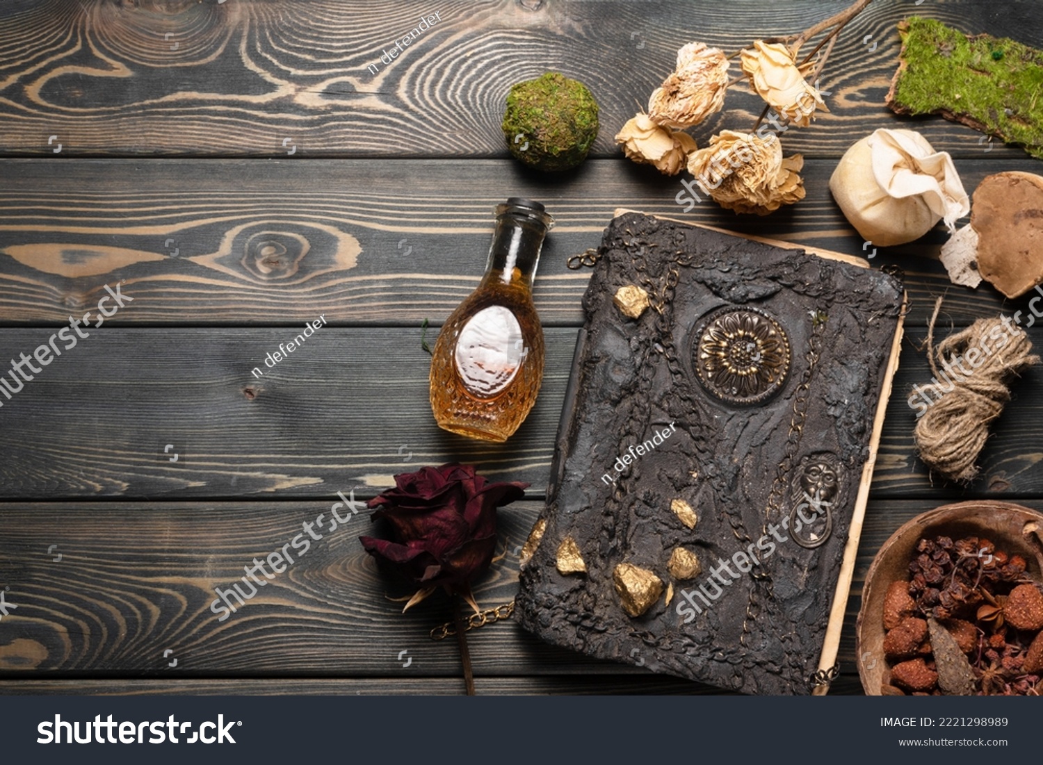 Old magic book and dry natural herbs and remedy bottle on the wooden table flat lay background with copy space. #2221298989