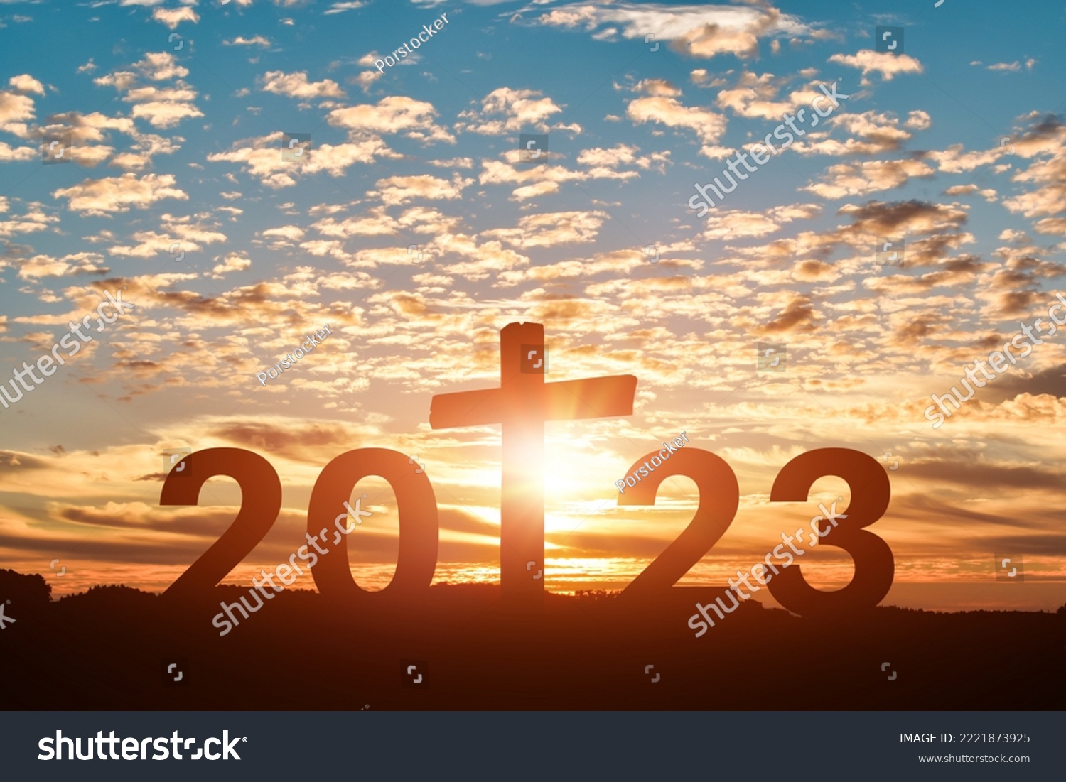 Silhouette of Christian cross with 2023 years at sunset background. Concept of Christians new year 2023 #2221873925