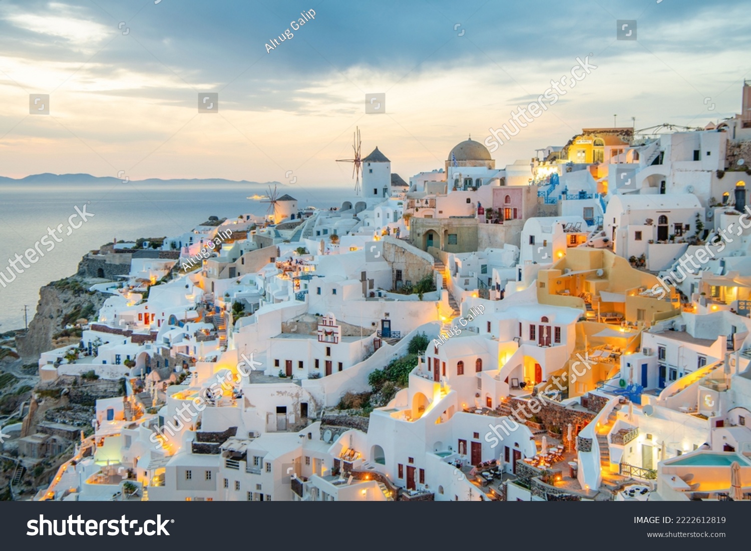 Scenic view of traditional cycladic white houses and blue domes in Oia village, Santorini island, Greece #2222612819