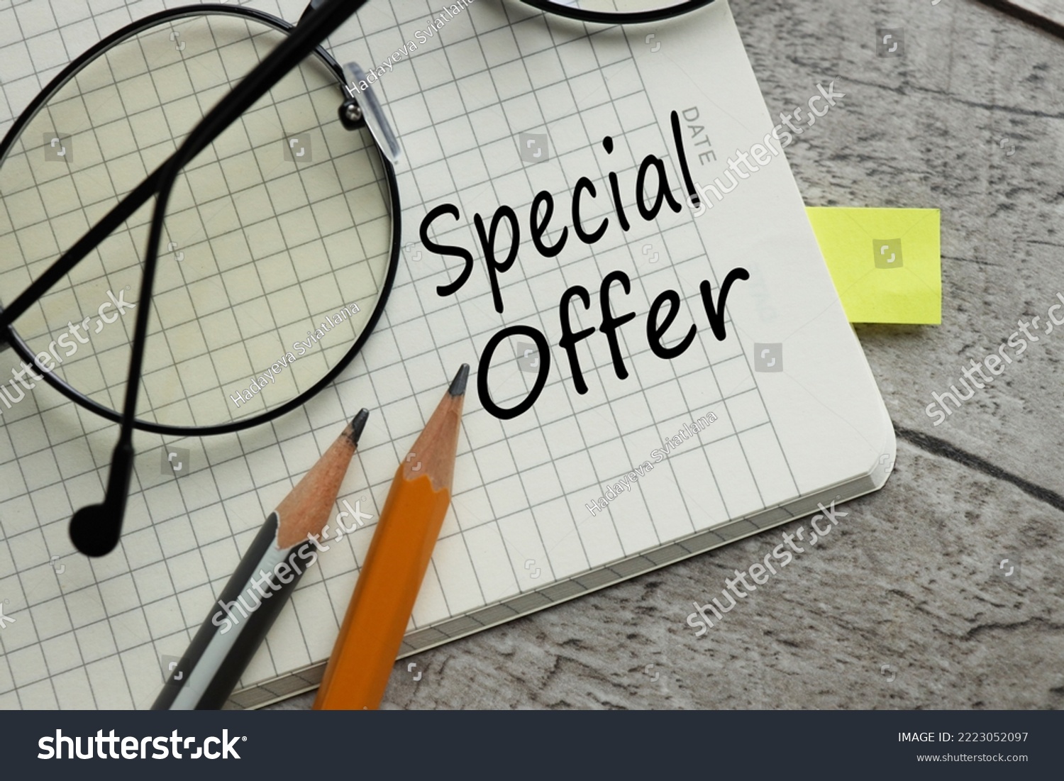 special offer text on a notebook page. near the pencils #2223052097