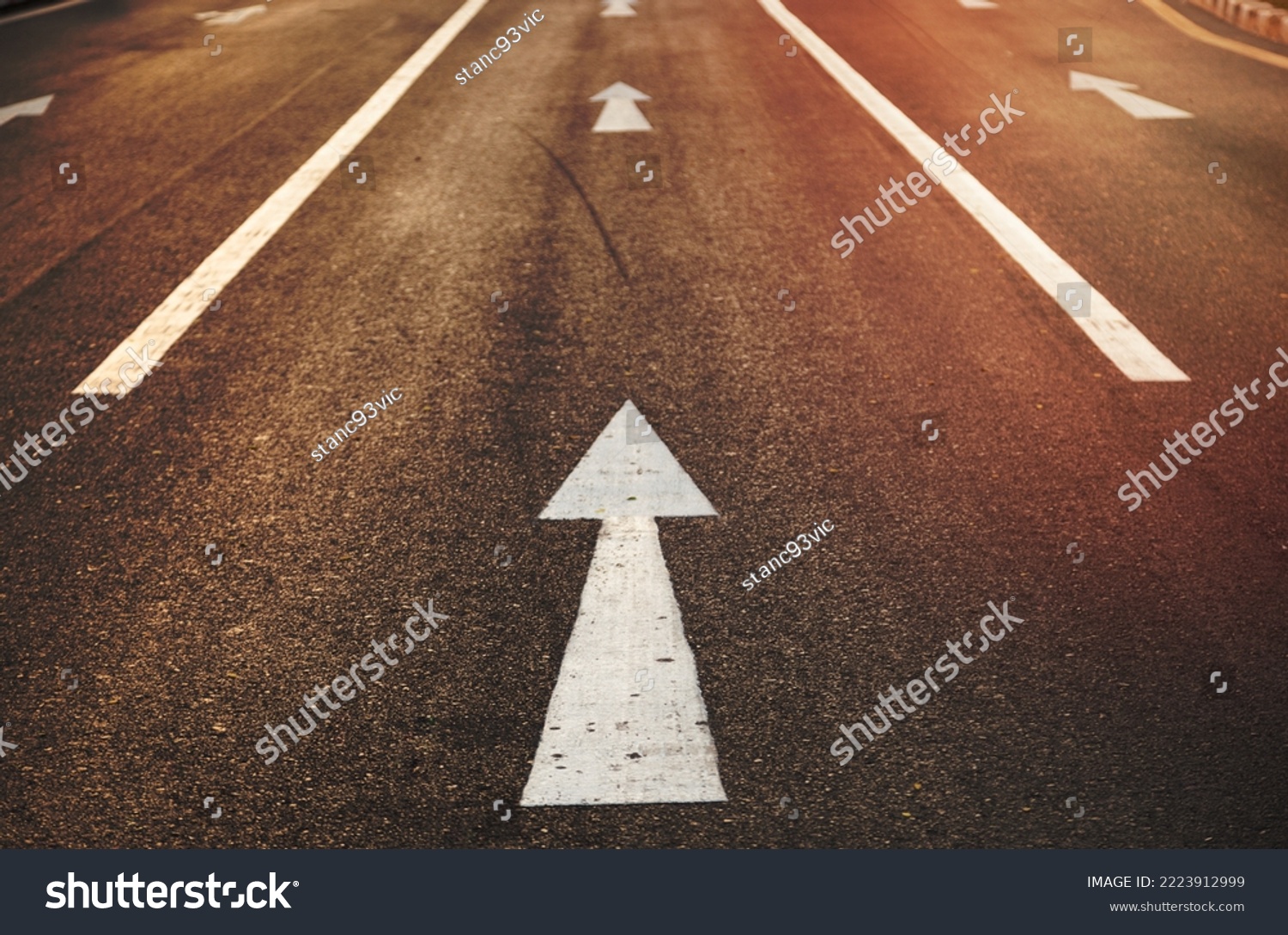 White arrow straight. Is on the road to a straight forward direction. #2223912999