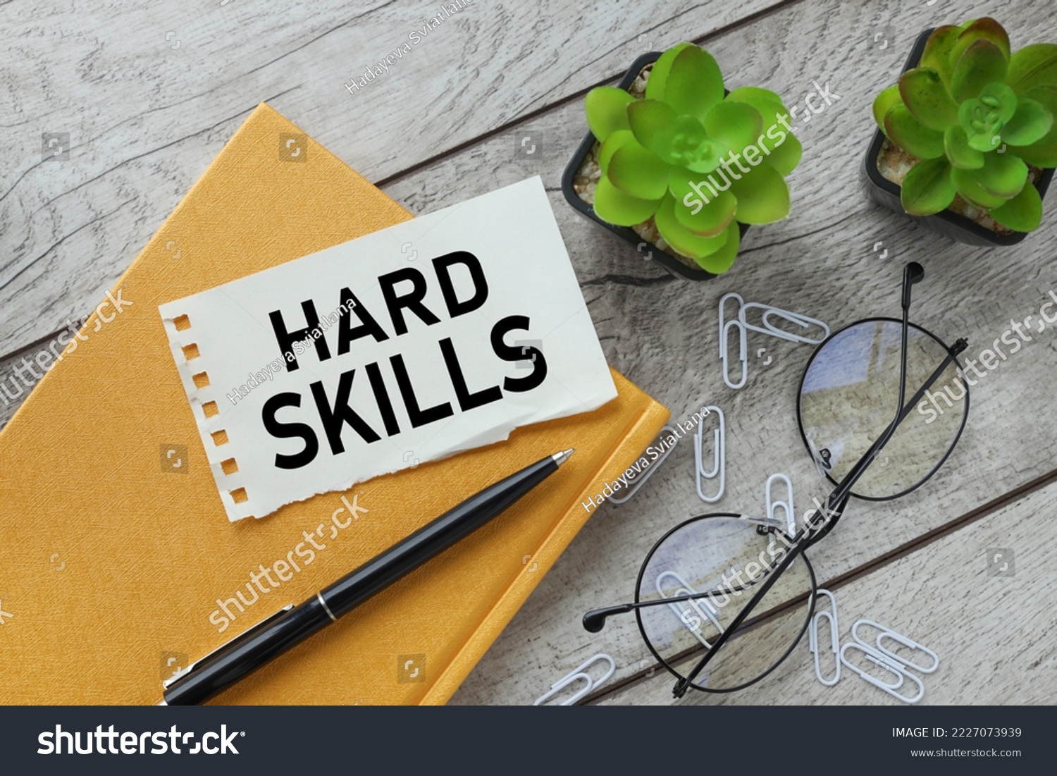 Business concept about Hard Skills beautiful working table plant in a pot. text on paper #2227073939