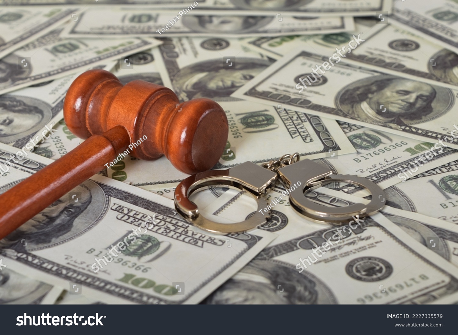Judge gavel, handcuffs and money banknotes. Economic crime, scam, bail and corruption concept. #2227335579
