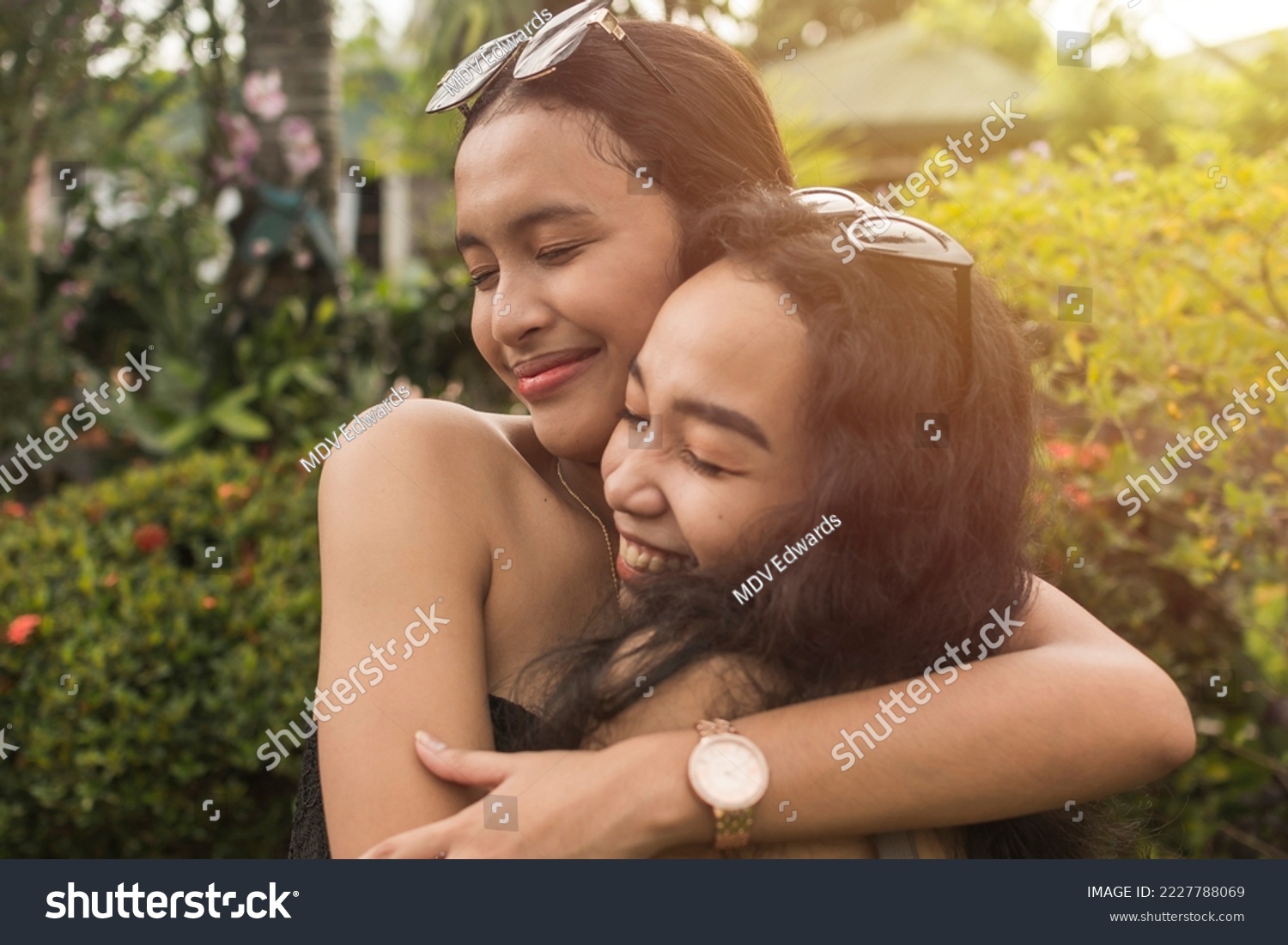 Candid blissful scene of two best friends hugging each other. Appreciating and cherishing their long years of friendship. #2227788069