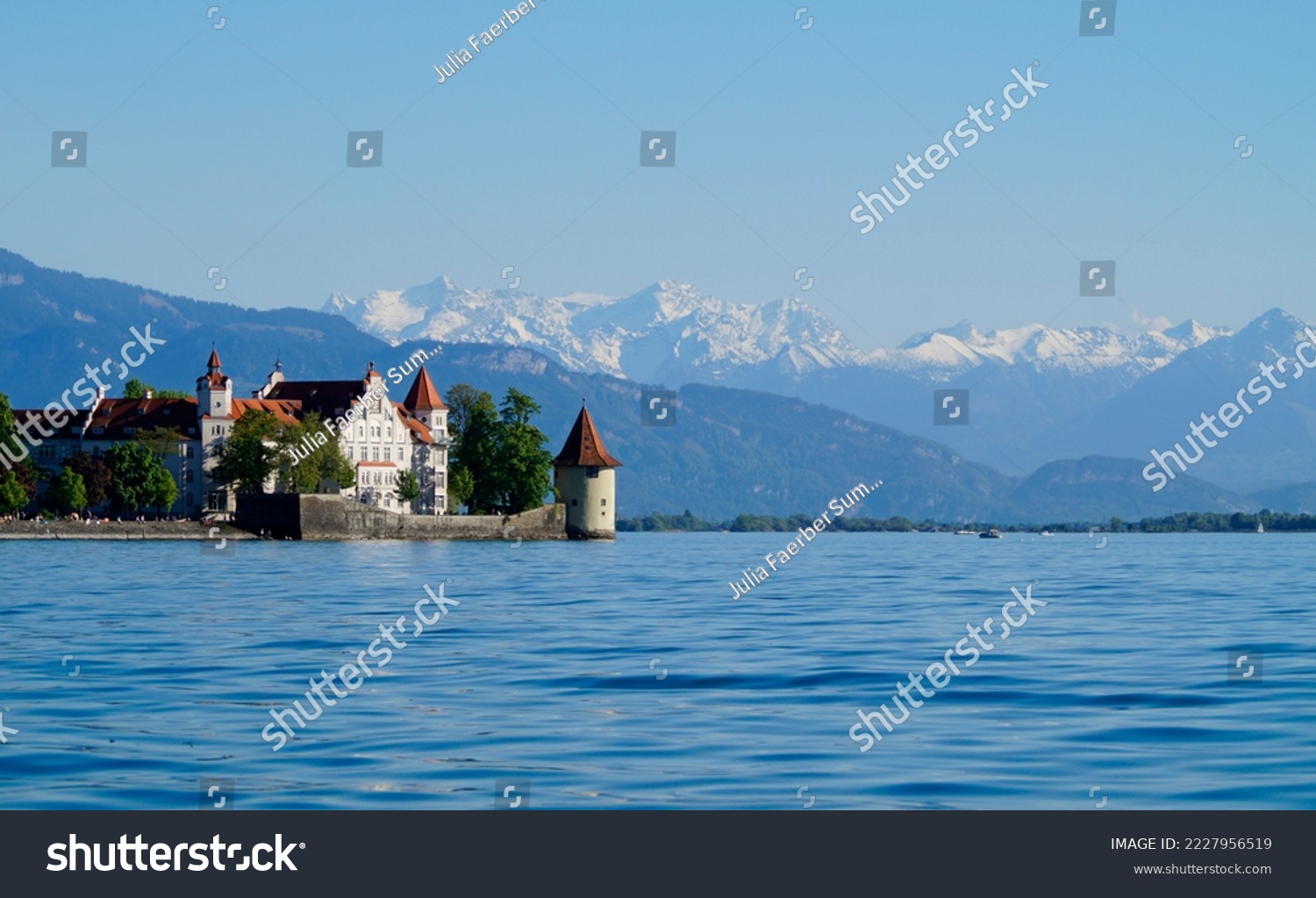 beautiful island of Lindau on lake Constance (lake Bodensee) with the snowy Swiss Alps in the background, Germany on fine sunny spring day                                #2227956519