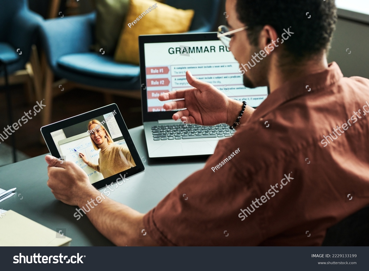 Young student communicating with teacher on tablet screen making presentation of new English grammar subject during online lesson #2229133199