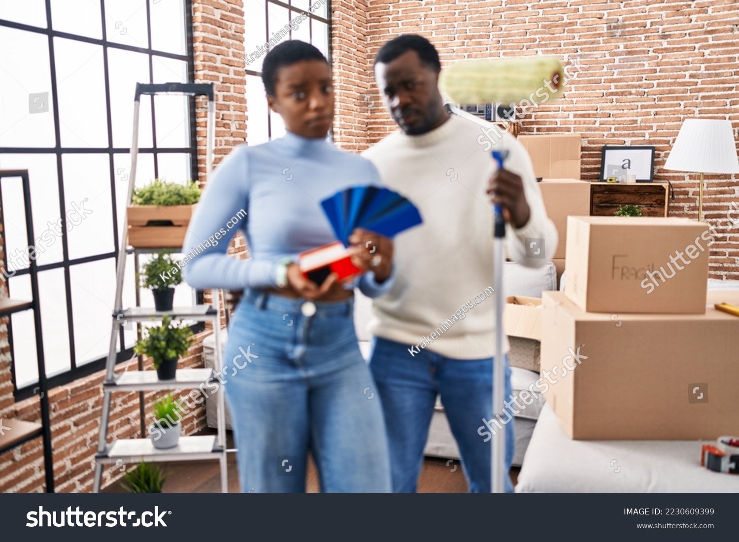 Young african american couple moving to a new home choosing walls color skeptic and nervous, frowning upset because of problem. negative person.  #2230609399