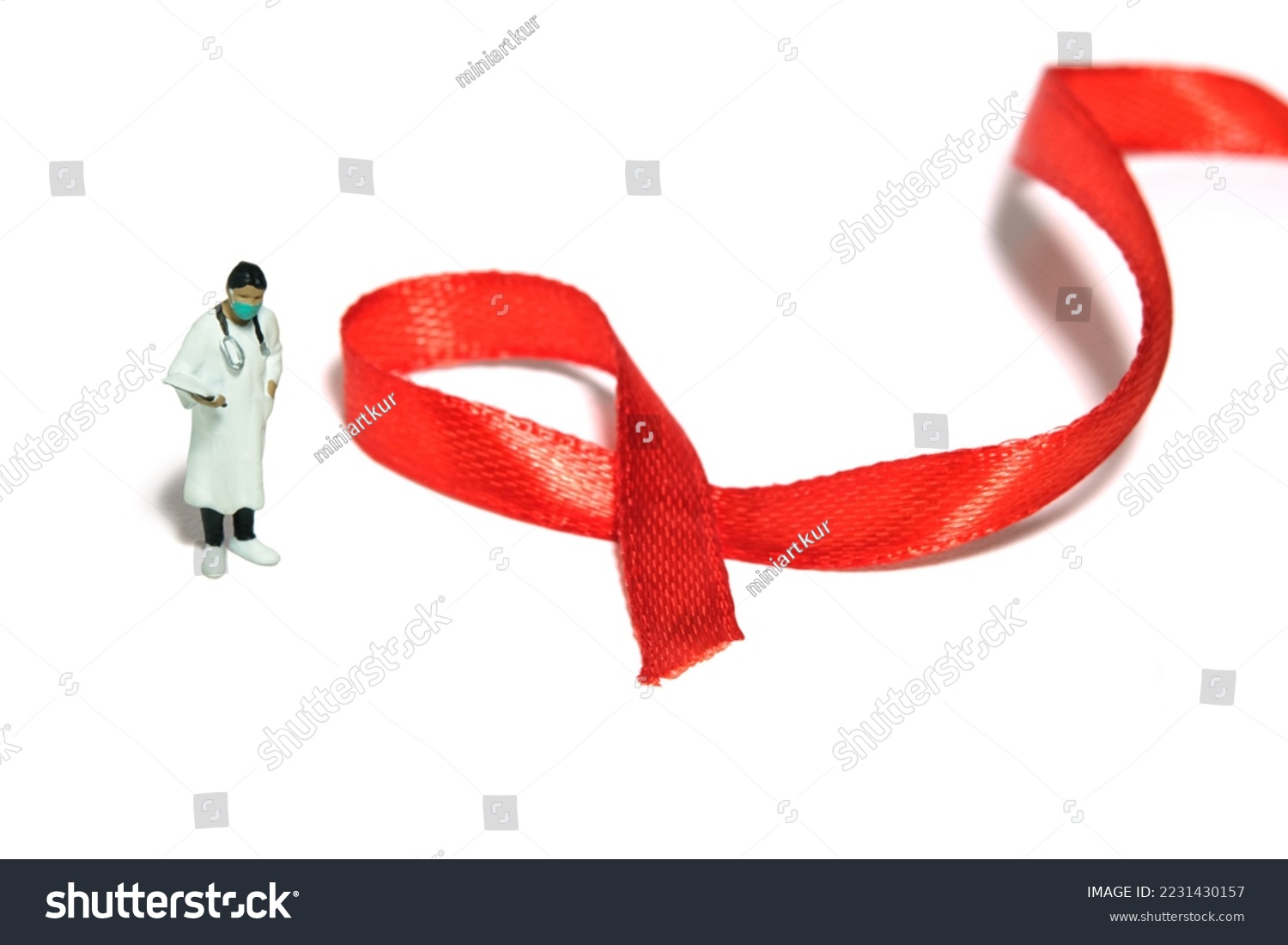 Miniature people figure toys photography. World AIDS Day awareness day concept. Girl woman doctor standing beside red ribbon. Isolated on white background. Image photo #2231430157