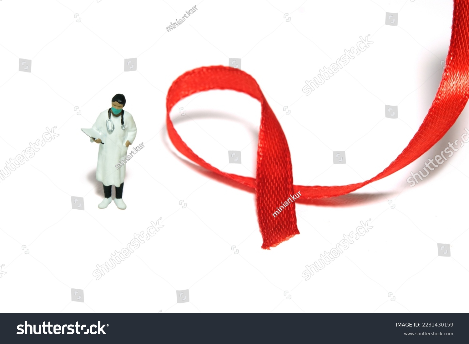 Miniature people figure toys photography. World AIDS Day awareness day concept. Girl woman doctor standing beside red ribbon. Isolated on white background. Image photo #2231430159