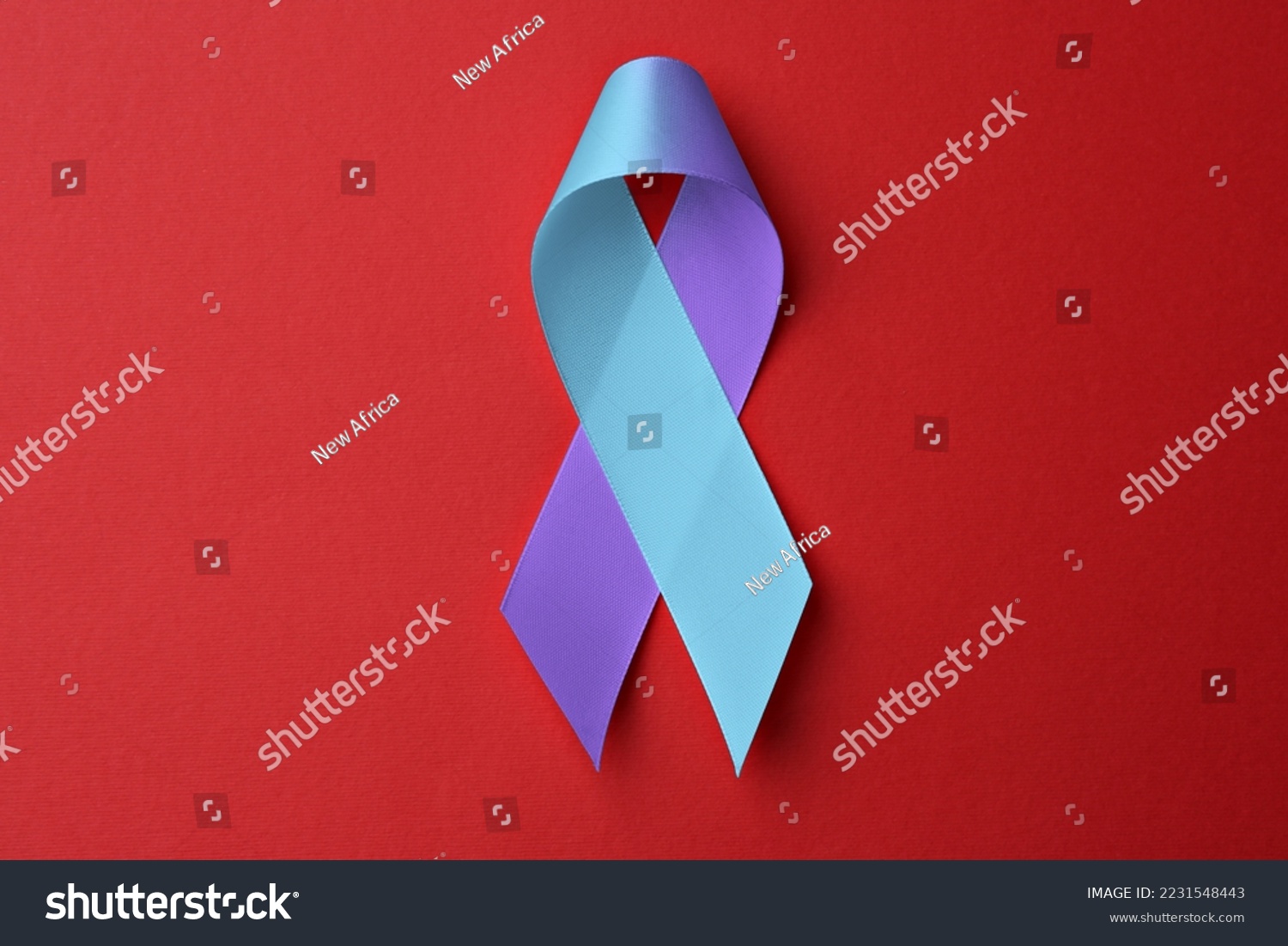 World Arthritis Day. Blue and purple awareness ribbon on red background, top view #2231548443