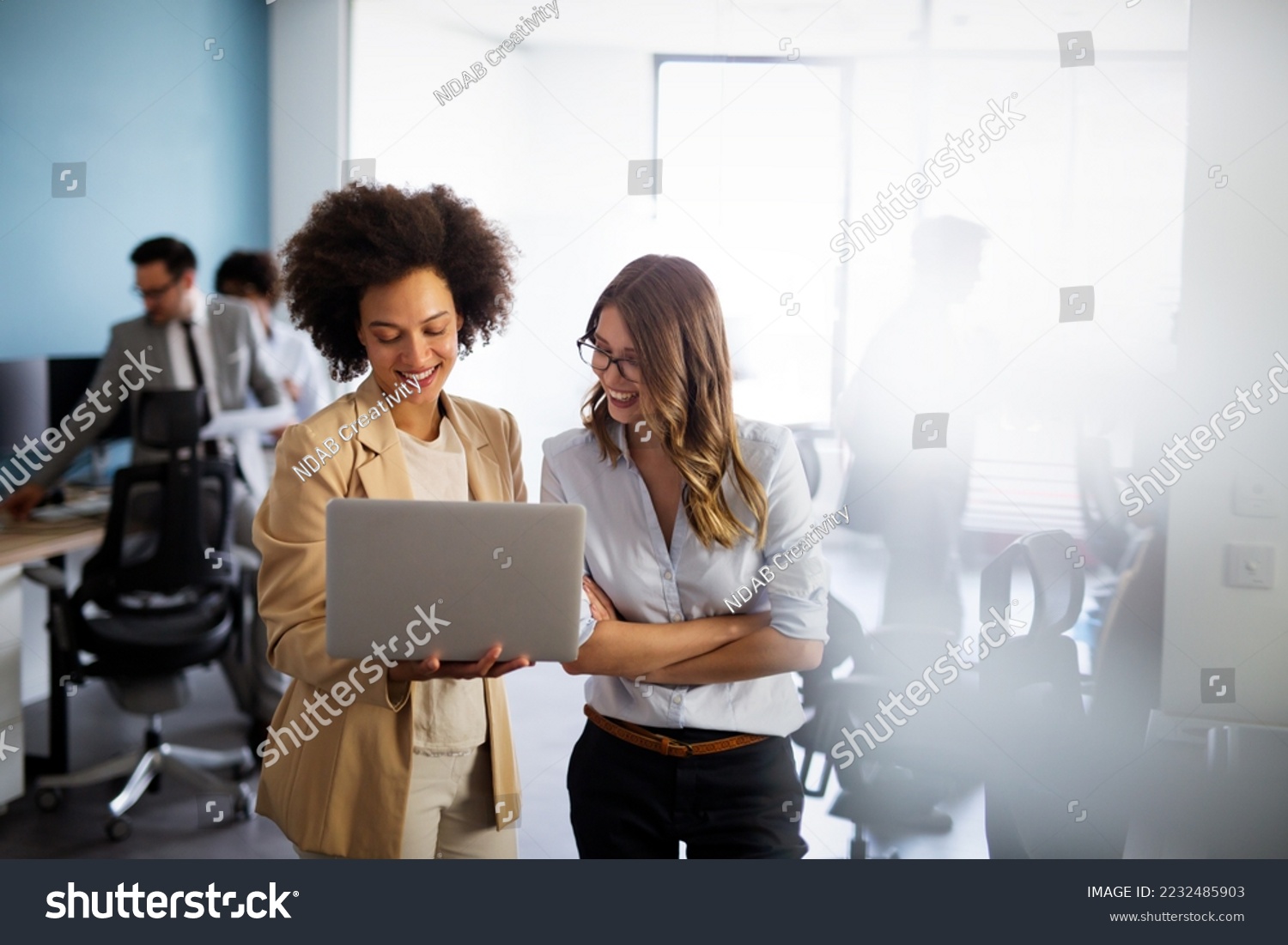 Happy multiethnic smiling business women working together in office #2232485903