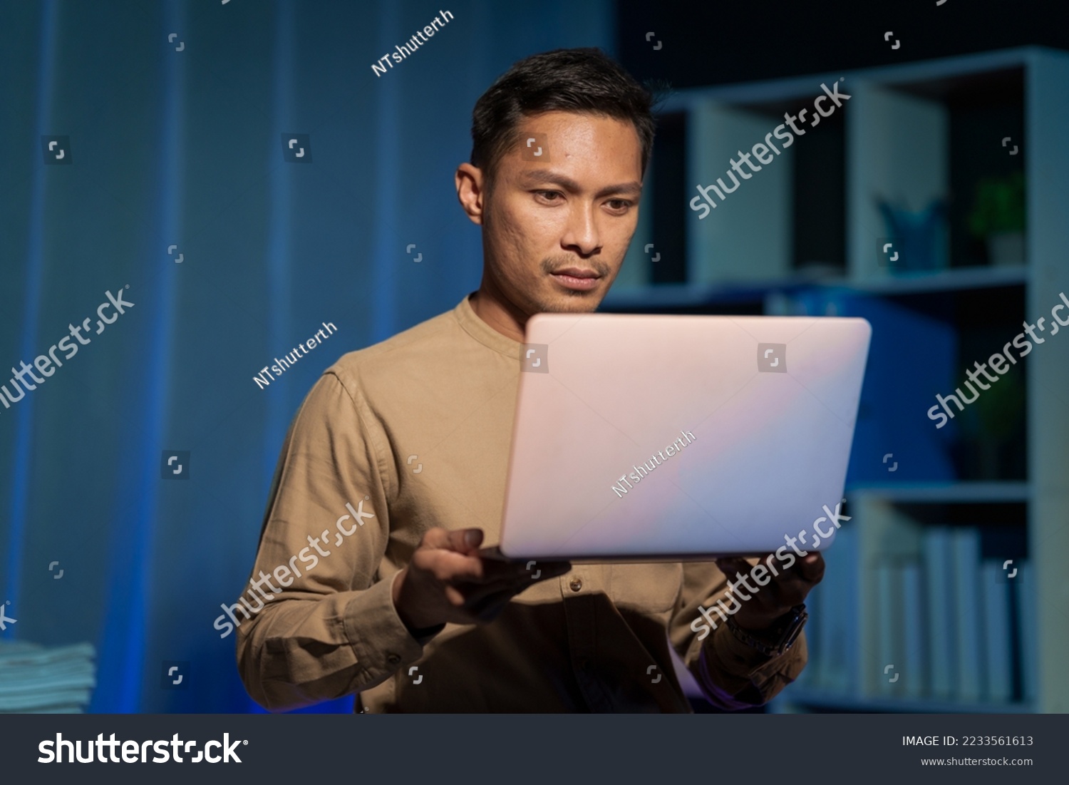 Overtime work concept, Handsome asian business man working late at night in office workplace. #2233561613