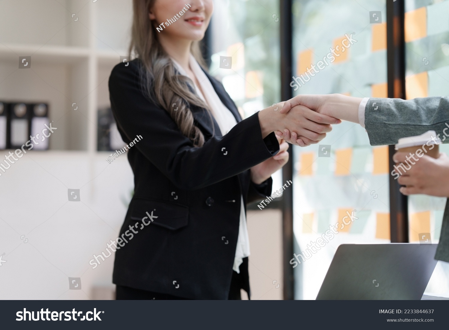 Female business worker with colleagues in Thailand working together at office desk, getting shaking hands, successful and agreement concept #2233844637