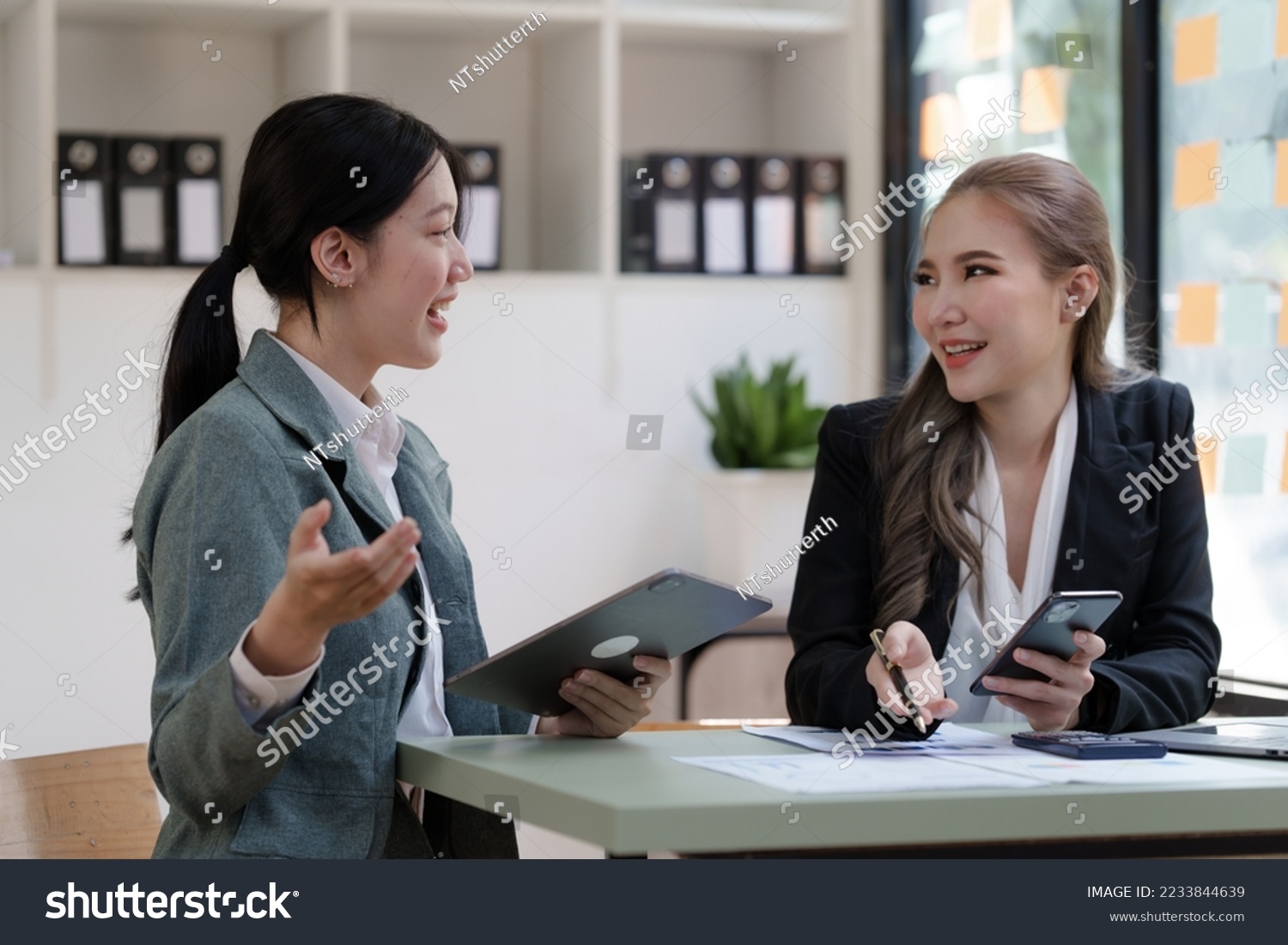 Female business worker with colleagues in Thailand working together at office desk, Female office worker business suit working with document file and paper work. #2233844639