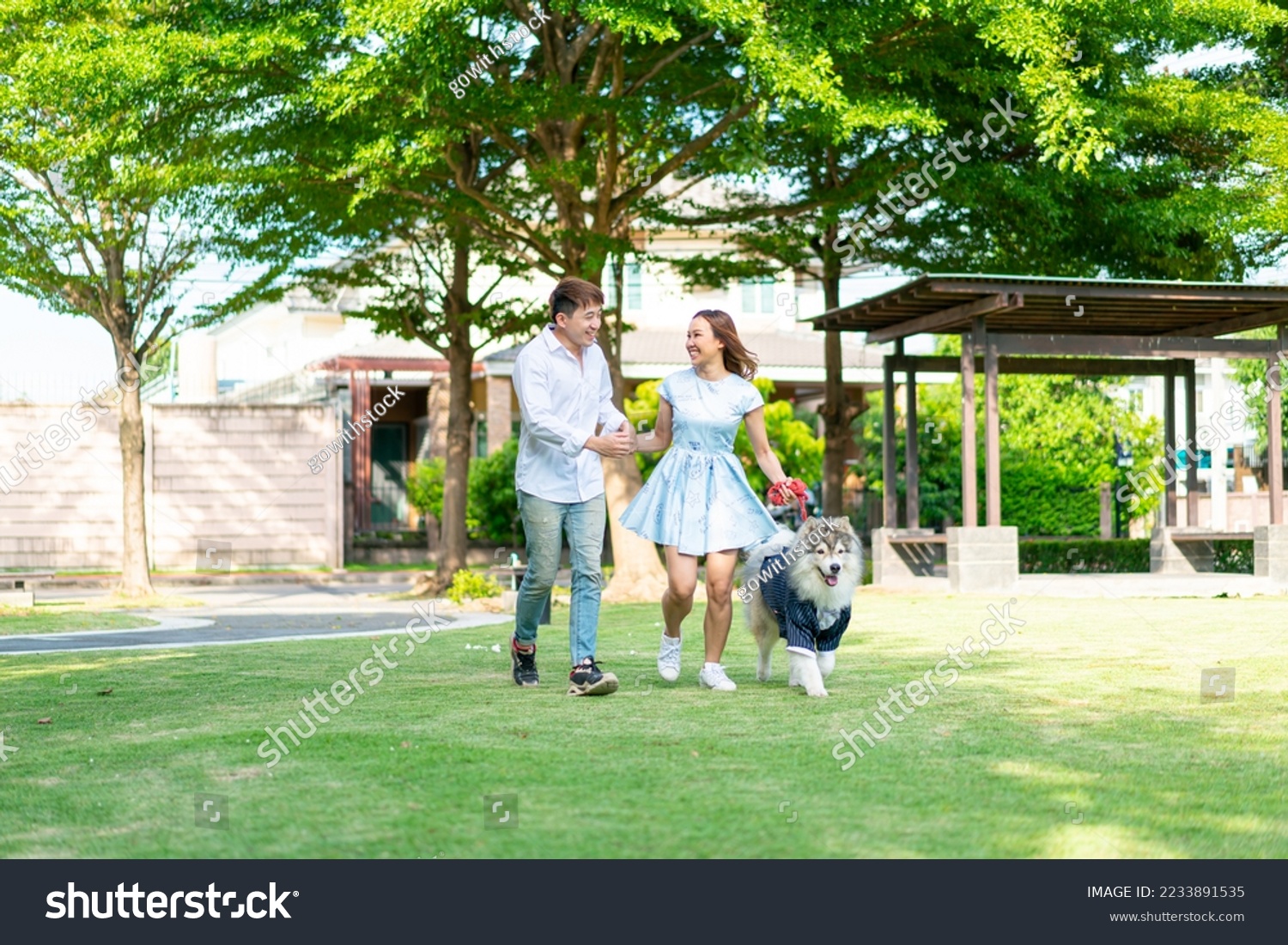 Asian couple love with cute dog in garden #2233891535