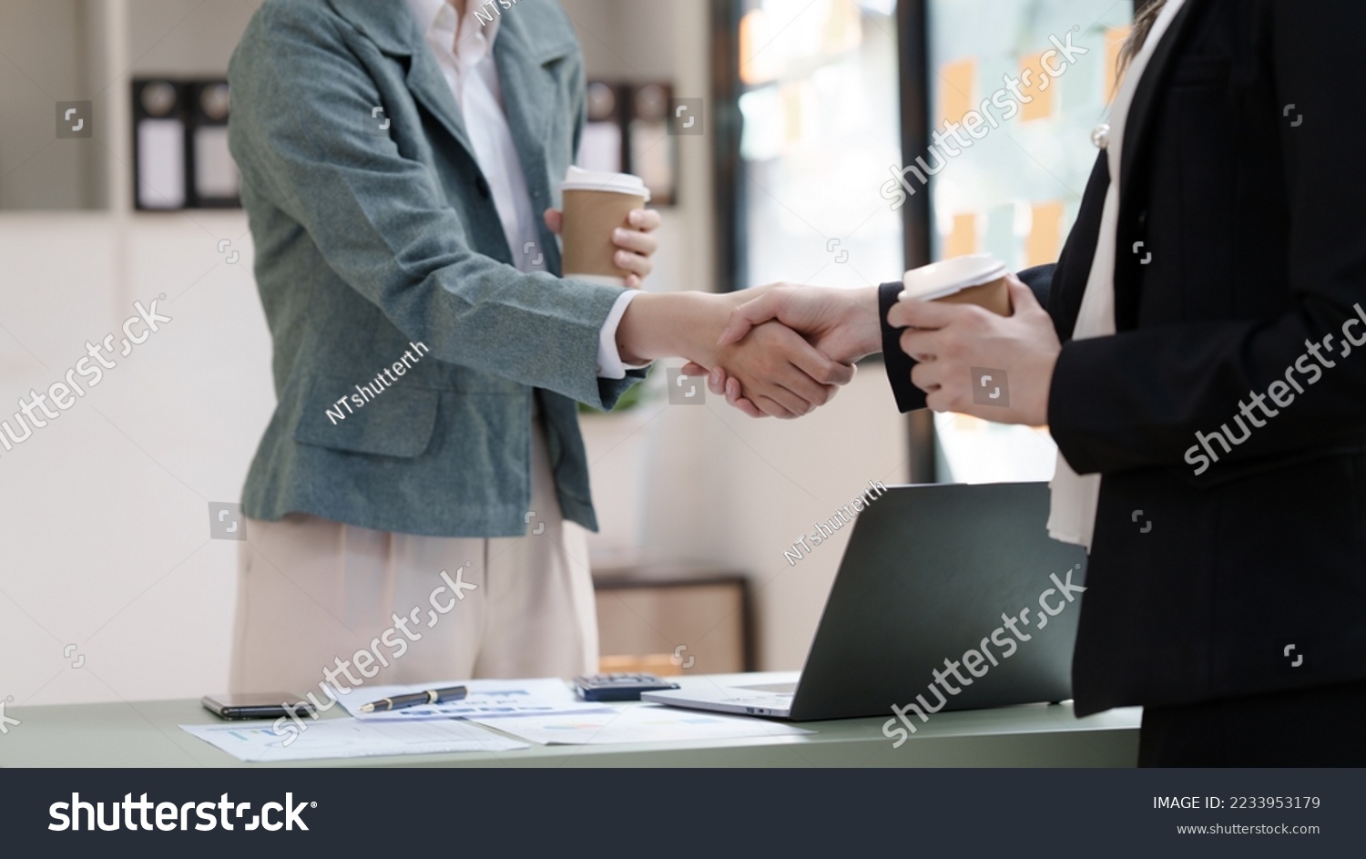 Female business worker with colleagues in Thailand working together at office desk, getting shaking hands, successful and agreement concept #2233953179