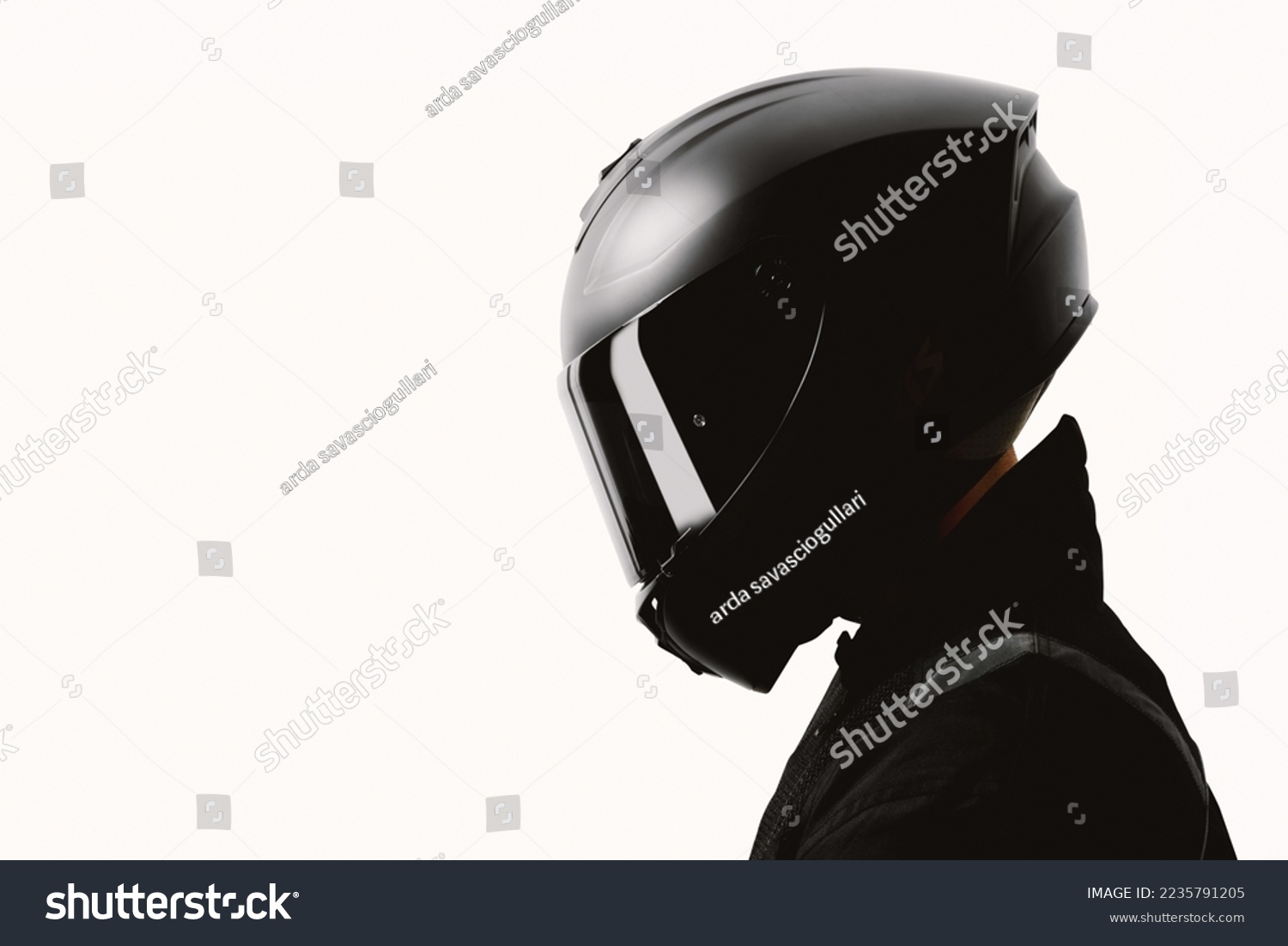Portrait of a motorcycle rider posing with a black helmet on a white background. #2235791205